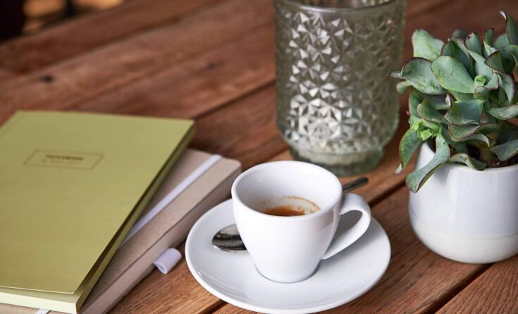 Pressemeldungen auf einem Tisch mit einem Kaffee Crema
